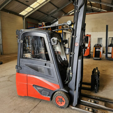 Vue latérale du chariot élévateur électrique FENWICK E16C01 avec mât triplex levée libre 6470 mm et déplacement latéral des fourches.